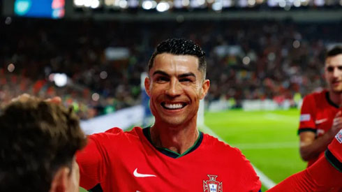 Cristiano Ronaldo smiles to his teammates and to the cameras