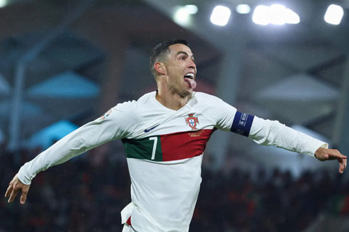 Cristiano Ronaldo scoring Portugal in a white shirt