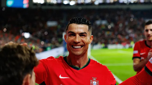 Cristiano Ronaldo smiling next to Portuguese teammates