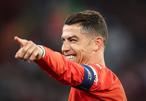 Cristiano Ronaldo points at someone and smiles