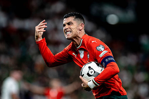 Cristiano Ronaldo grabs ball after scoring for Portugal