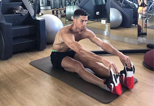 Cristiano Ronaldo stretching his thighs