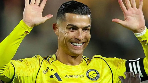 Cristiano Ronaldo raises his two hands to celebrate with teammate