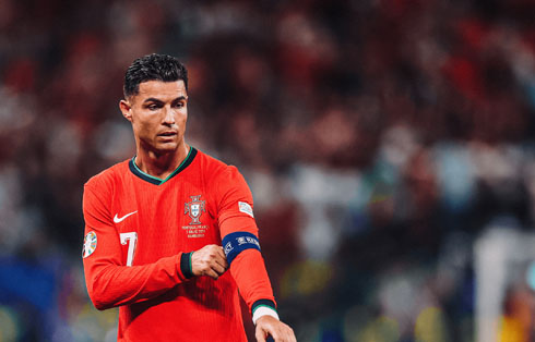 Cristiano Ronaldo sorting out his captain armband