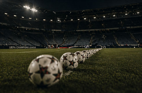 Football balls lined up on a football pitch