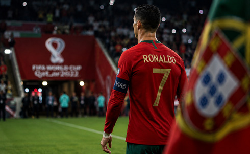 Cristiano Ronaldo next to Portugal flag
