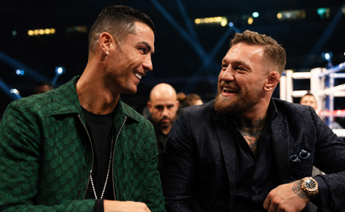 Cristiano Ronaldo sits next to Conor McGregor