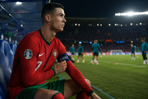 Cristiano Ronaldo on the bench holding his armband