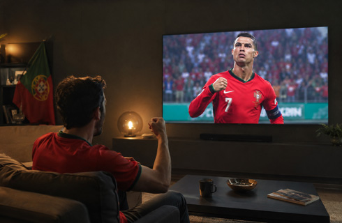 Sports fans watching Ronaldo play on TV