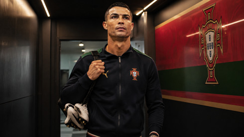 Cristiano Ronaldo walking past a Portugal wall