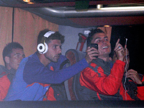 Cristiano Ronaldo taking photos of the Bosnian crowd, from the Portuguese National Team bus, with Miguel Veloso doing the same behind him