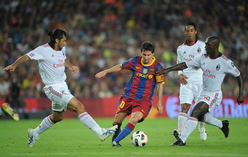 Seedorf trying to steal the ball from Lionel Messi, in a Barcelona vs AC Milan game, for the UEFA Champions League 2011-2012
