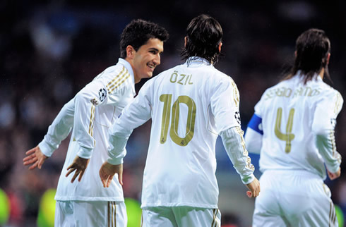 Nuri Sahin smiling to Mesut Ozil, with Sergio Ramos close by