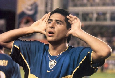 Riquelme celebrating a goal in Boca Juniors, attempting to hear the fans in the crowd