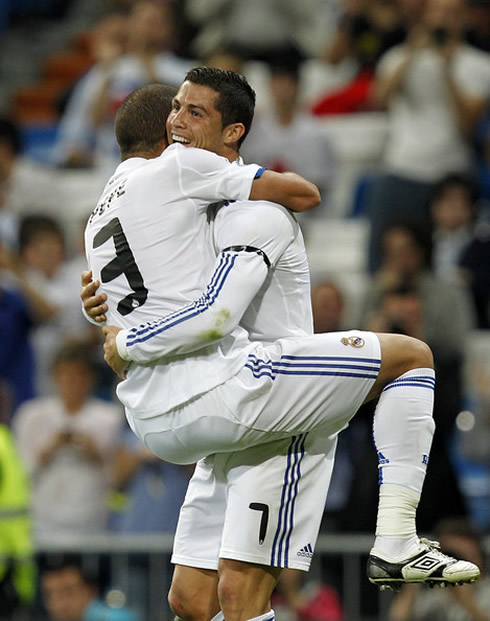 Cristiano Ronaldo holding Pepe on his lap, in a bit of a gay position