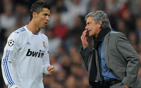 José Mourinho telling a secret to Cristiano Ronaldo