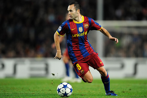 Andrés Iniesta, playing for FC Barcelona and running with the ball