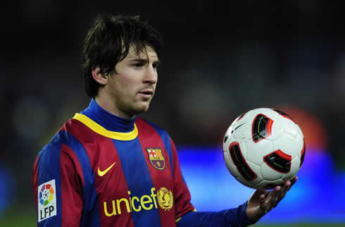 Lionel Messi holding a soccer ball