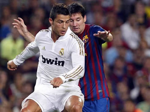 Cristiano Ronaldo and Lionel Messi, fighting for the ball in Real Madrid vs Barcelona