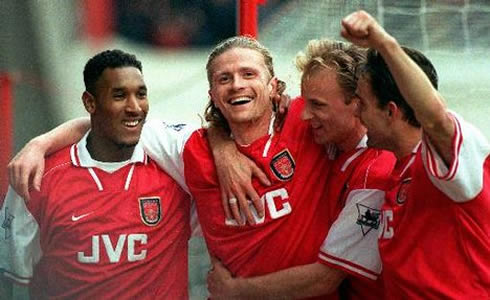 Petit, Nicolas Anelka, Dennis Bergkamp and Marc Overmars, in a team hug at Arsenal