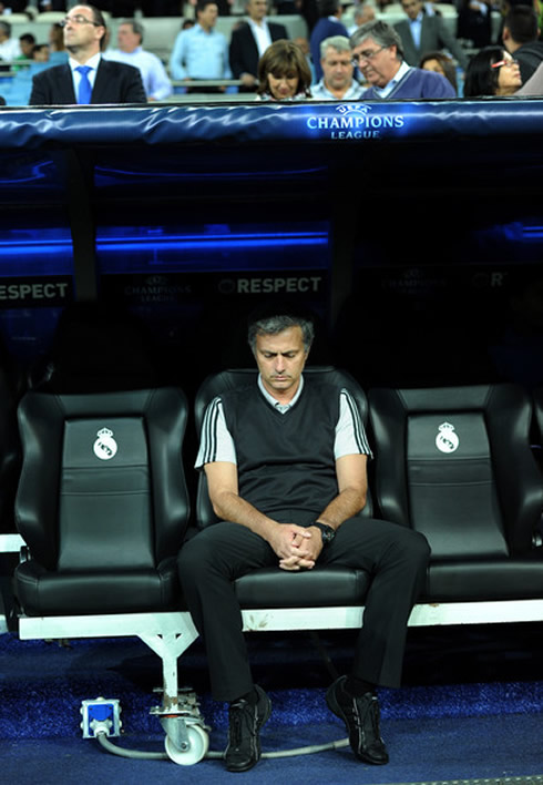 José Mourinho with a strapless jacket/jersey, meditating at Real Madrid bench
