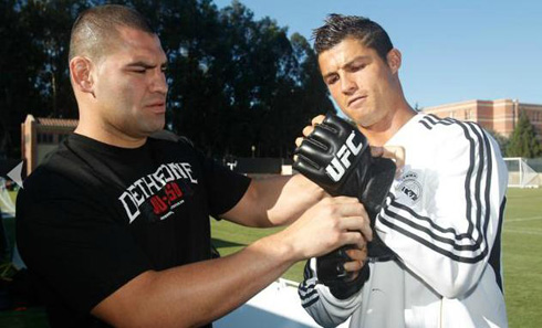 Cristiano Ronaldo wearing UFC training gloves sibe by side with Cain Velasquez