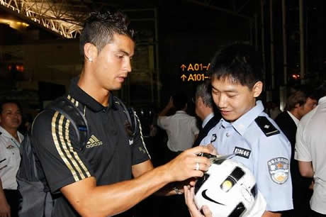 Real Madrid signing an autograph to a fan from police in Guangzhou, China