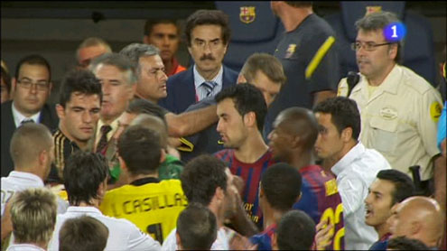 José Mourinho putting his finger on Tito Vilanova (or pulling ears)