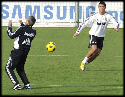 Cristiano Ronaldo chasing a ball, with José Mourinho watching closely