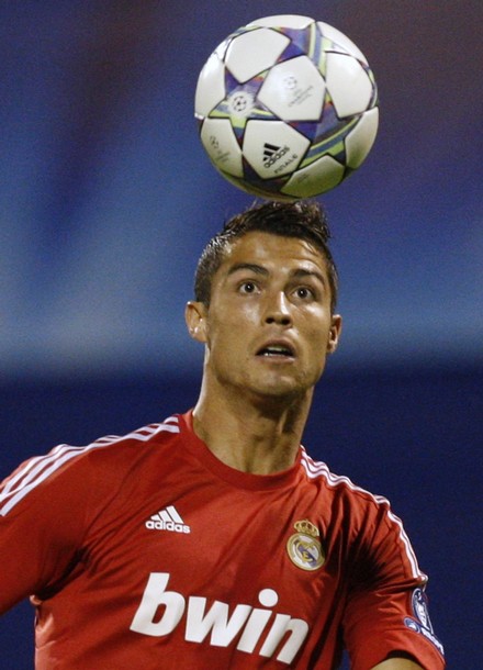 Cristiano Ronaldo heading the ball against Dinamo Zagreb, using Real Madrid new red jersey