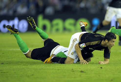 Cristiano Ronaldo falling above a Racing Santander defender in the Spanish League La Liga 2011-2012