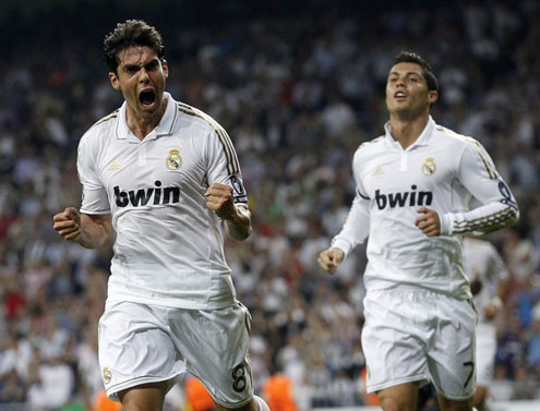 Kaká celebrating his first goal in the 2011-2012 Champions League, while Cristiano Ronaldo runs behind him to join the party