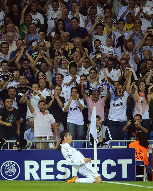 Cristiano Ronaldo celebrating a goal by sliding on his knees towards the Santiago Bernabéu crowd in extasy