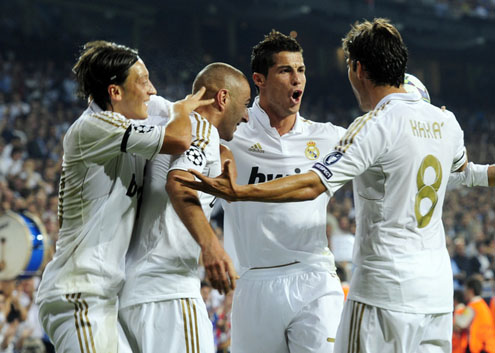 Cristiano Ronaldo hugging his teammates, Benzema, Kaká and Ozil celebrating a Real Madrid goal against Ajax, in the UCL 2011-2012