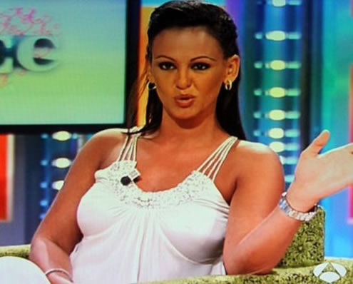 Nereida Gallardo in a TV talk show, wearing a sensual white dress
