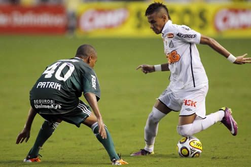 Neymar dribbling a defender while playing for Santos, in Brazil