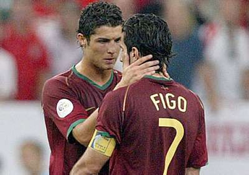 Cristiano Ronaldo holding Figo neck while he talks seriously with him