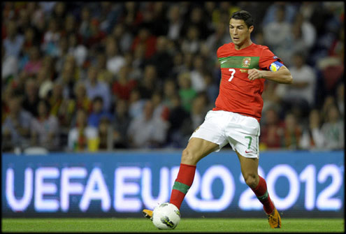 Cristiano Ronaldo controls the ball and attempts to progress on the field against Iceland