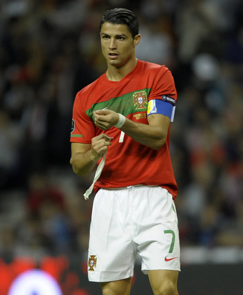 Cristiano Ronaldo removes his white bracelets from his wrists, in the Portuguese National Team