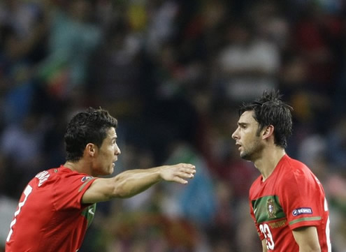 Cristiano Ronaldo tells Hélder Postiga what to do, while make gestures to help him understand better