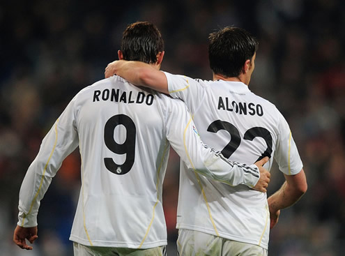 Xabi Alonso hugs Cristiano Ronaldo as they walk back to their half, after a Real Madrid goal in 2009-2010