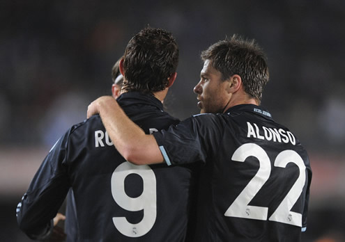 Xabi Alonso talks to Cristiano Ronaldo in the all-black Real Madrid jerseys