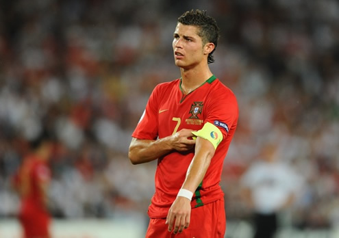 Cristiano Ronaldo placing the Portuguese captaincy armband on his left arm