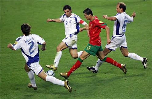 Cristiano Ronaldo running with the ball, while being surrounded by Greek defenders in the Euro 2004 Final