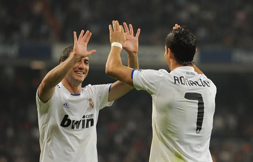 Gonzalo Higuaín and Cristiano Ronaldo touching hands in Real Madrid