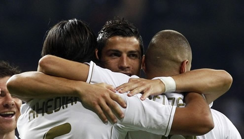 Cristiano Ronaldo hugging his teammates, Sami Khedira and Karim Benzema