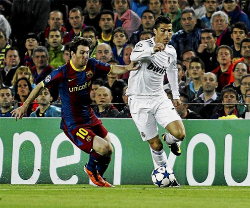 Cristiano Ronaldo and Lionel Messi chasing the ball in a Real Madrid vs Barcelona match 2011-2012