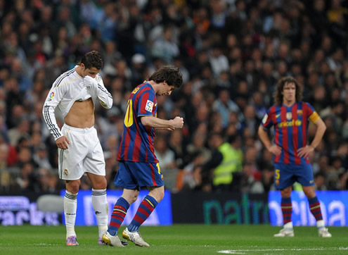 Cristiano Ronaldo thinking about his life, while Lionel Messi celebrates near him