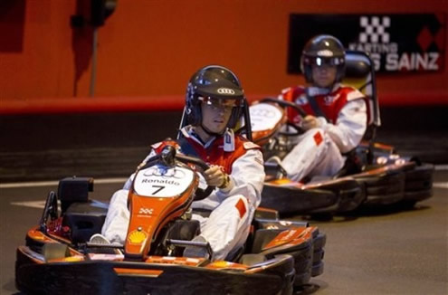 Cristiano Ronaldo driving a kart car, in a Carlos Sainz race