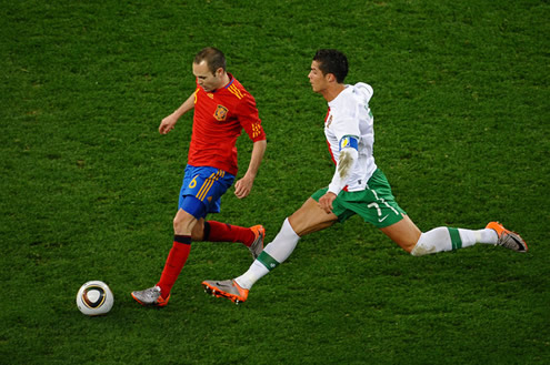 Andrés Iniesta being chased by Cristiano Ronaldo, in a Spain vs Portugal match